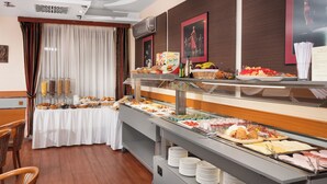 A buffet setup with various food items and a table with a white tablecloth. - Hotel Kálvária (Gyor)