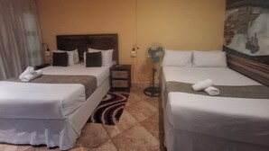 A hotel room with two single beds, a nightstand, a wall-mounted fan, and a painting. - Sgegede Guest House (Pretoria)