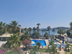 2 outdoor pools, open 9:00 AM to 6:00 PM, pool umbrellas, pool loungers