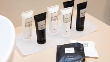 A display of skincare products including body cream, conditioner, and shower gel, along with a vanity set.