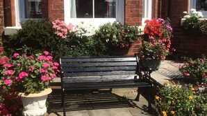 A bench in front of a building with a 'No Vacancies' sign. - Glenora Guest House (Whitby)