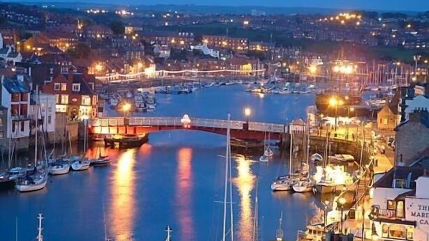 A harbor with boats, a bridge, and buildings along the waterfront. - Glenora Guest House (Whitby)