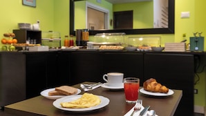 A breakfast setting with a table set for two, including plates with toast, an omelette, a croissant, a cup of coffee, and a glass of juice. - Chic & Town Luxury Rooms Piazza del popolo (Rome)