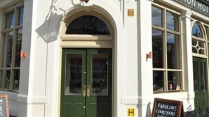 A building with a green door and the sign "The Station Hotel" above it. - The Station Hotel (London)