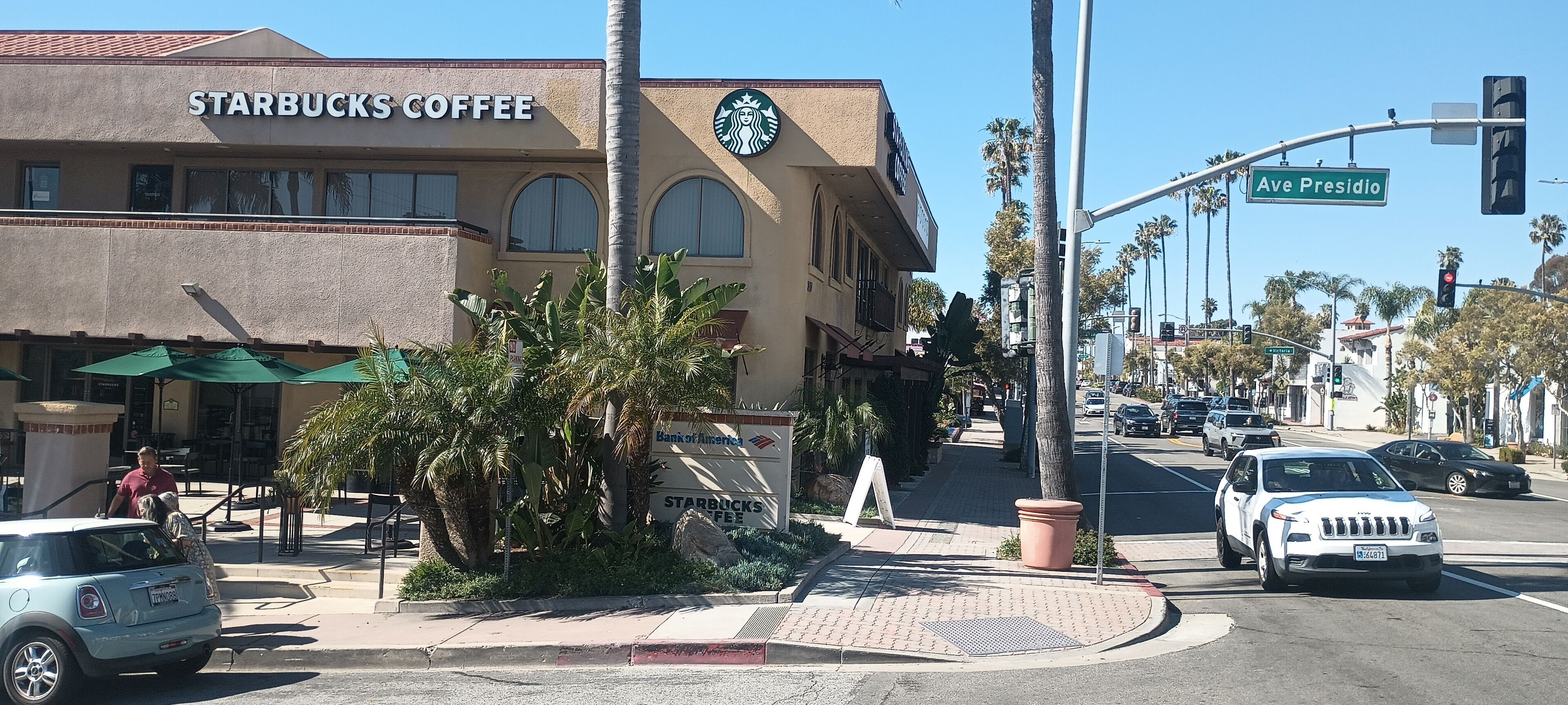 A Starbucks Coffee building with a sign for Bank of America.