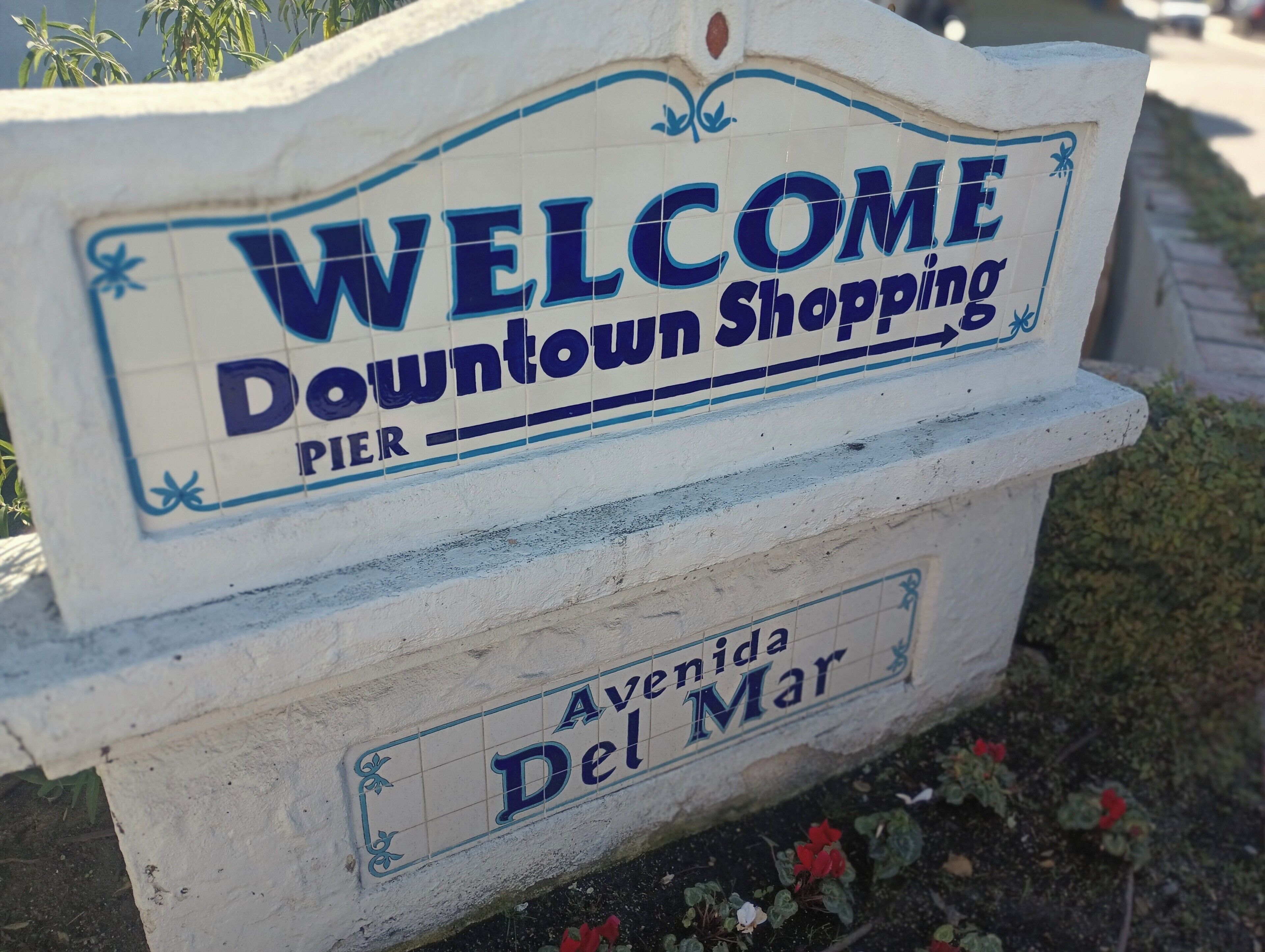 A welcome sign for Downtown Shopping Pier, Avenue Del Mar.