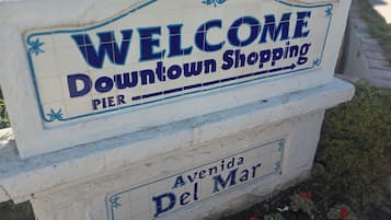 A welcome sign for Downtown Shopping Pier, Avenue Del Mar.
