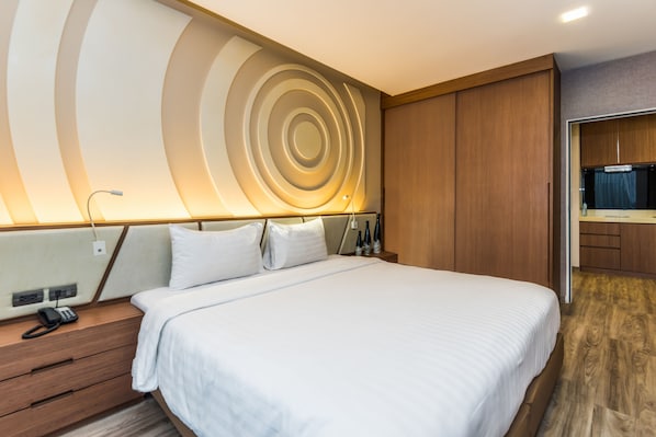 A modern hotel room with a large bed, wooden headboard, and a unique circular wall design. - Olive Bangkok Hotel (Bangkok)