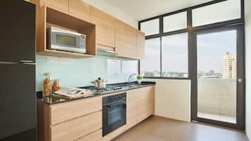 Three-Bedroom Family Room | Private kitchen | Fridge, microwave, stovetop, highchair