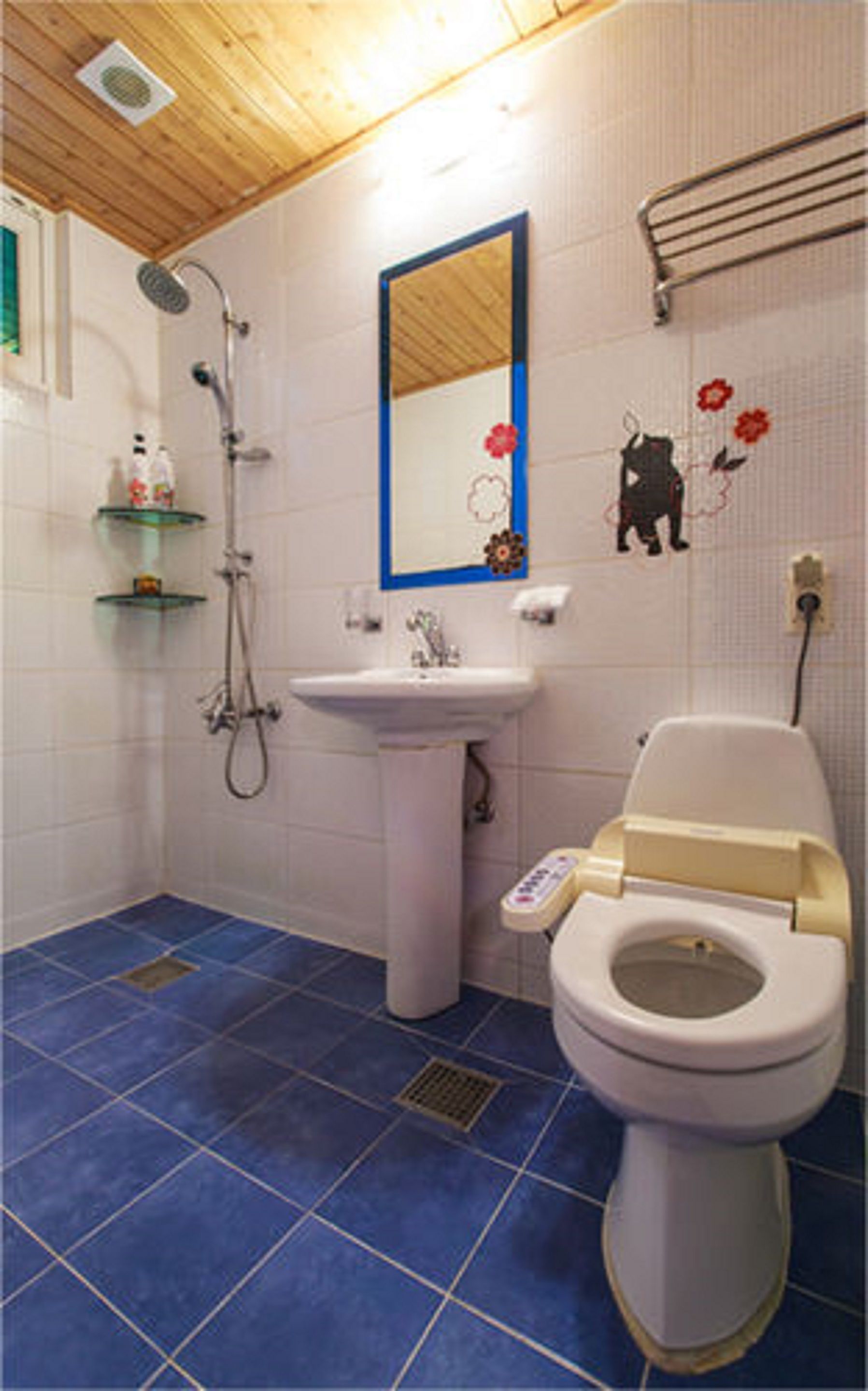 A bathroom with a toilet, sink, and shower.