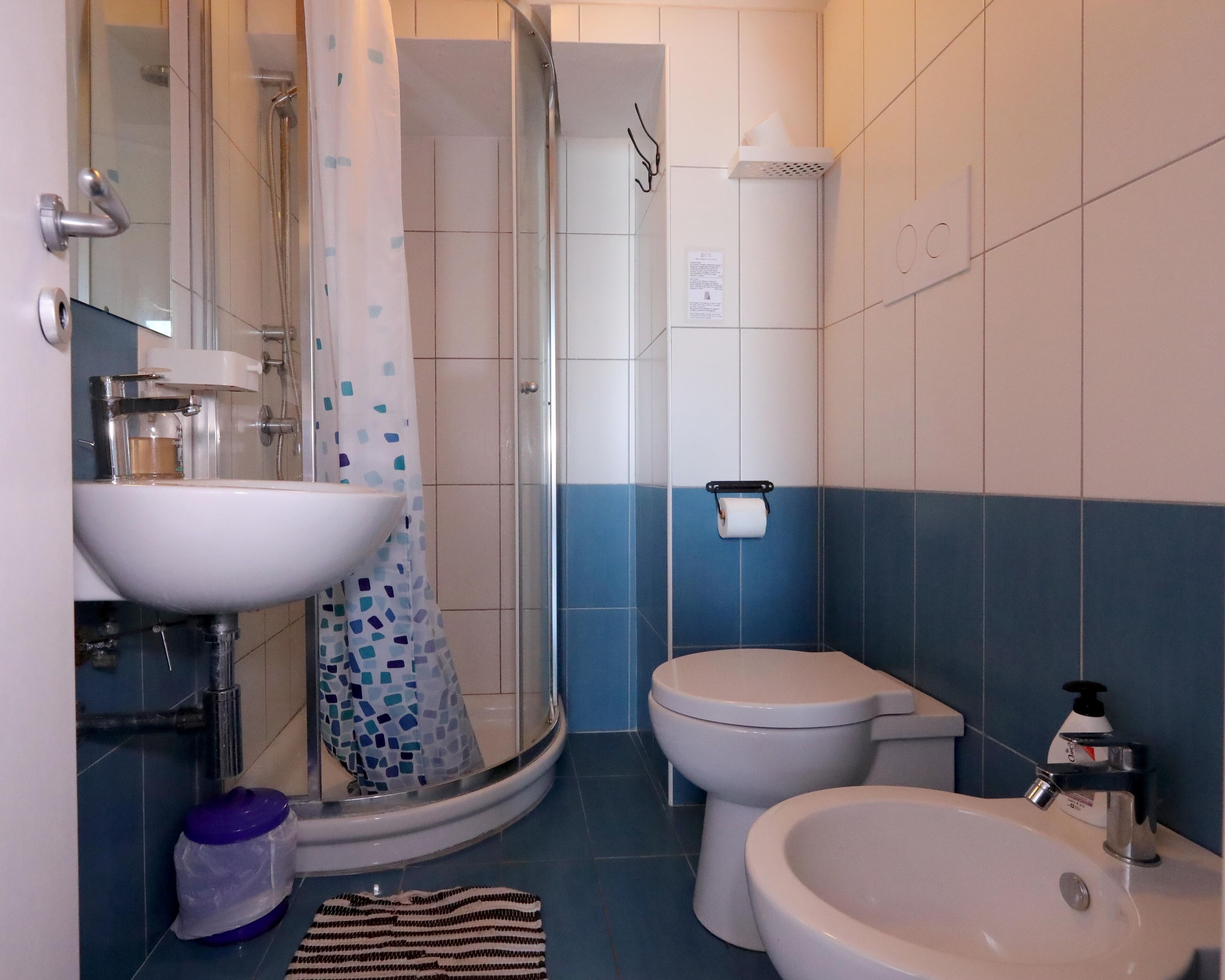 A bathroom with a sink, toilet, and shower.
