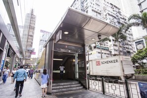 A modern building with a sign for Tsim Sha Tsui Station. - Joyous Guest House (Kowloon)