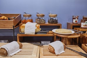 A breakfast buffet with various food items, including pastries, bread, and condiments in jars. - Odalys City Apartment Hotel - Toulouse Centre Gare (Toulouse)