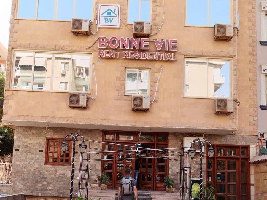 A multi-story building with a sign reading "BONNE VIE RENT RESIDENTIAL".