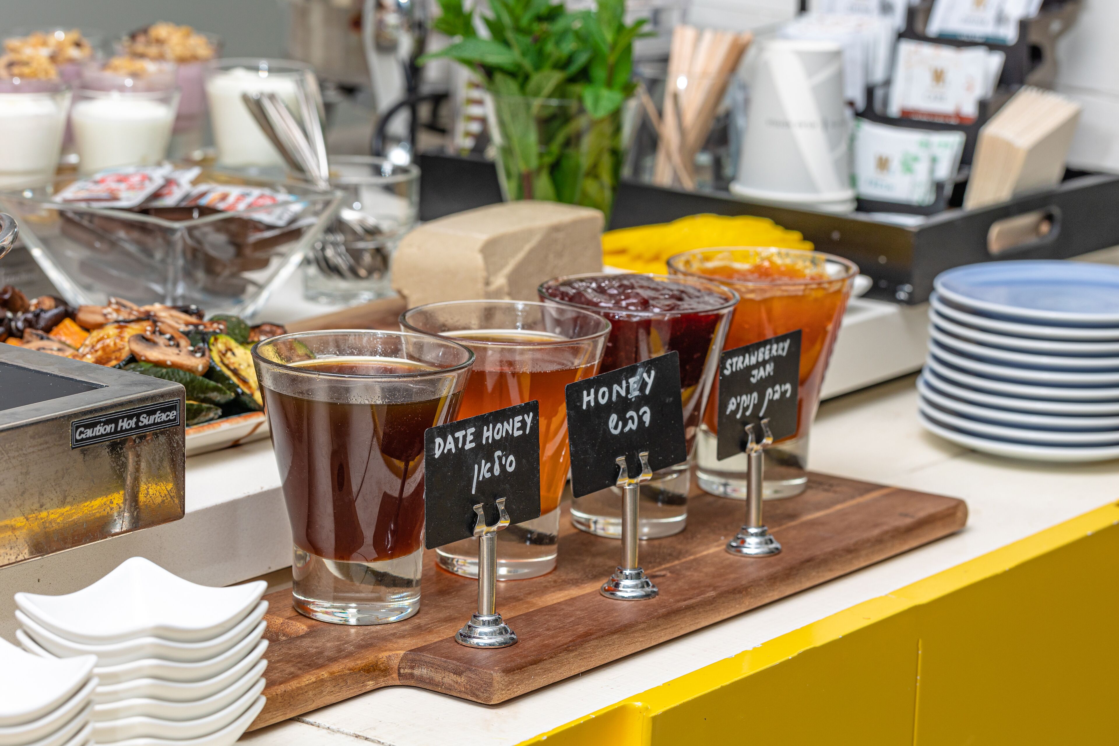 A beverage station with various drinks and a caution sign.