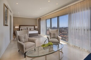 Luxury Suite | Living area | 40-inch flat-screen TV with cable channels, TV