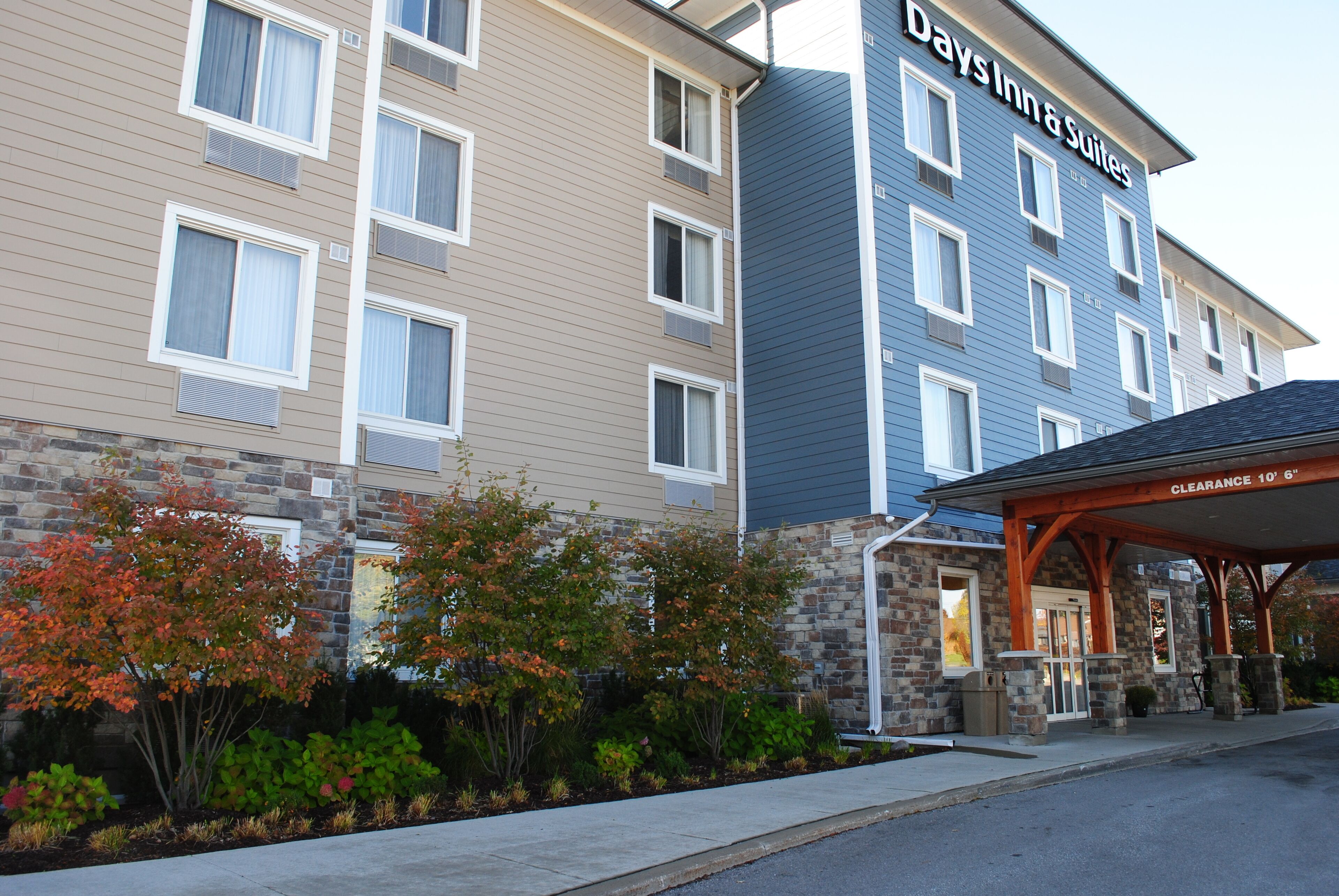 A multi-story hotel with a stone facade and a blue upper section.