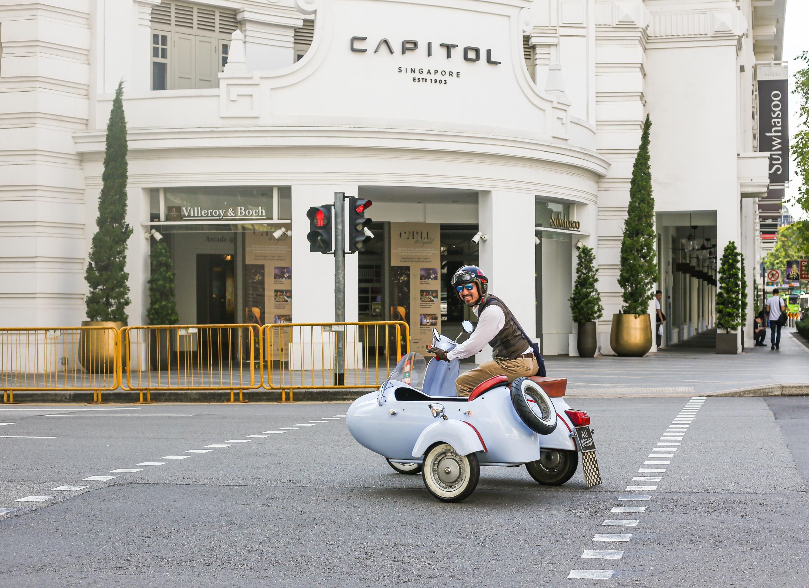 A vintage motorcycle with a sidecar on a city street.