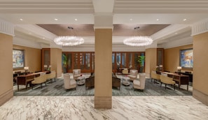 A hotel lobby with marble flooring, seating arrangements, and decorative lighting. - The Capitol Kempinski Hotel Singapore (Singapore)
