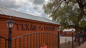 A wooden wall with the text "TEXAS LODGES" and a star emblem. - Texas Star Lodges (Floresville)