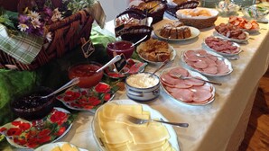 A buffet table with various food items including meats, cheeses, and desserts. - Hotel Bergblick (Pomerode)