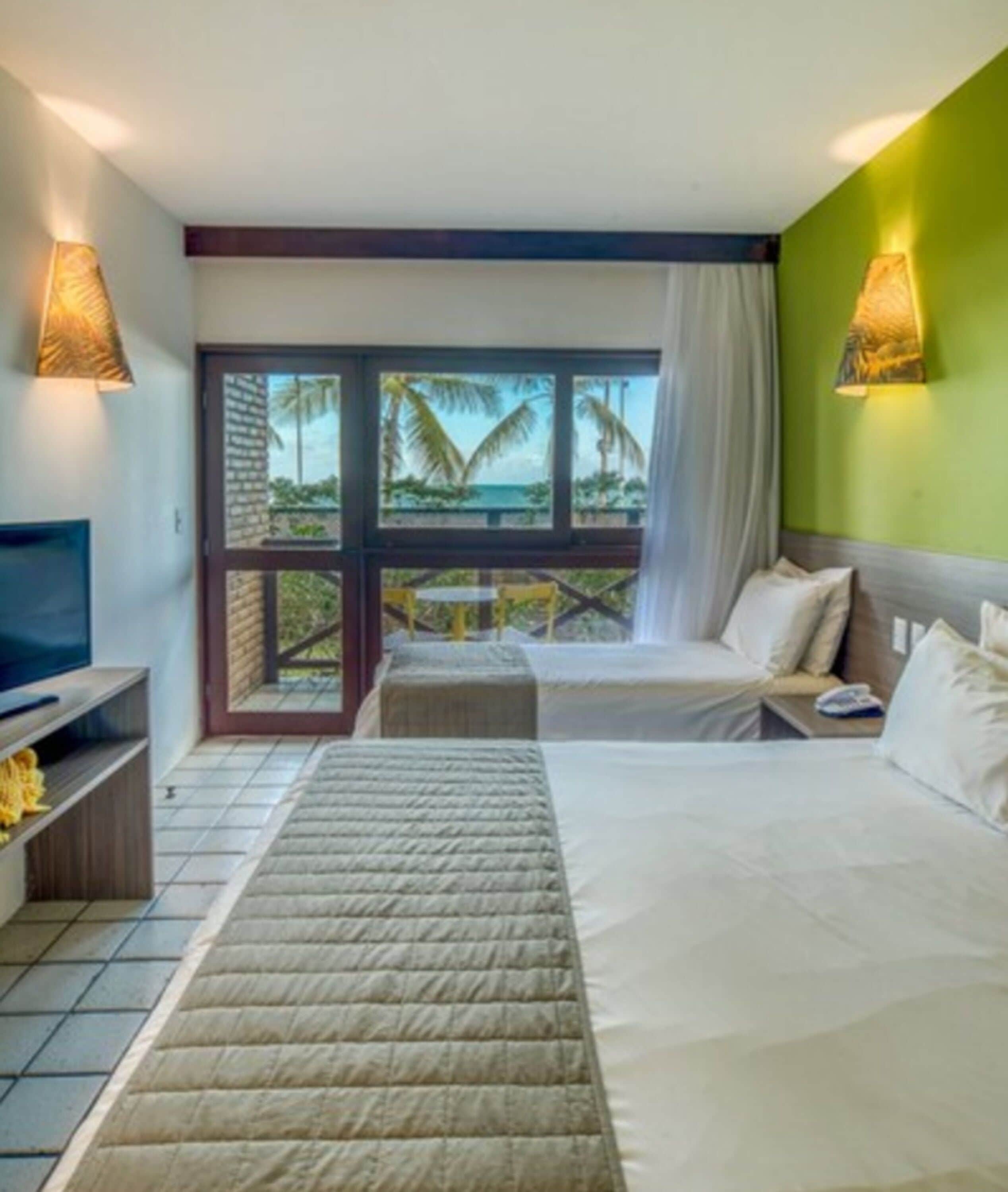 Triple Room, Sea View | Minibar, individually decorated, individually furnished, desk