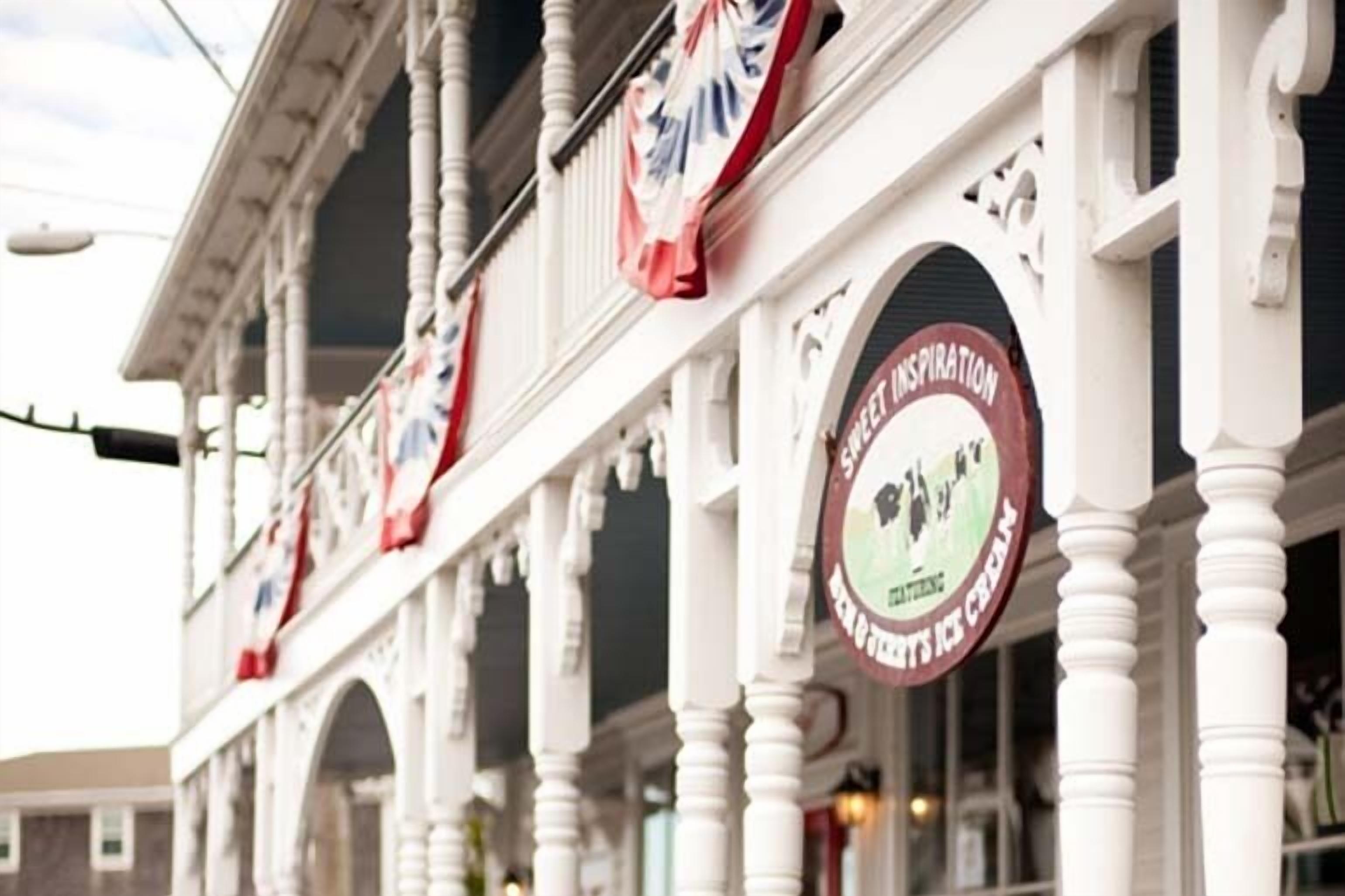 A building with white columns and a sign that reads "Sweet Inspiration Ice Cream."