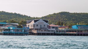 A waterfront property with a prominent building labeled 'Sunita A' featuring a balcony and a dock extending into the water. - Suntosa Resort (Koh Lan)