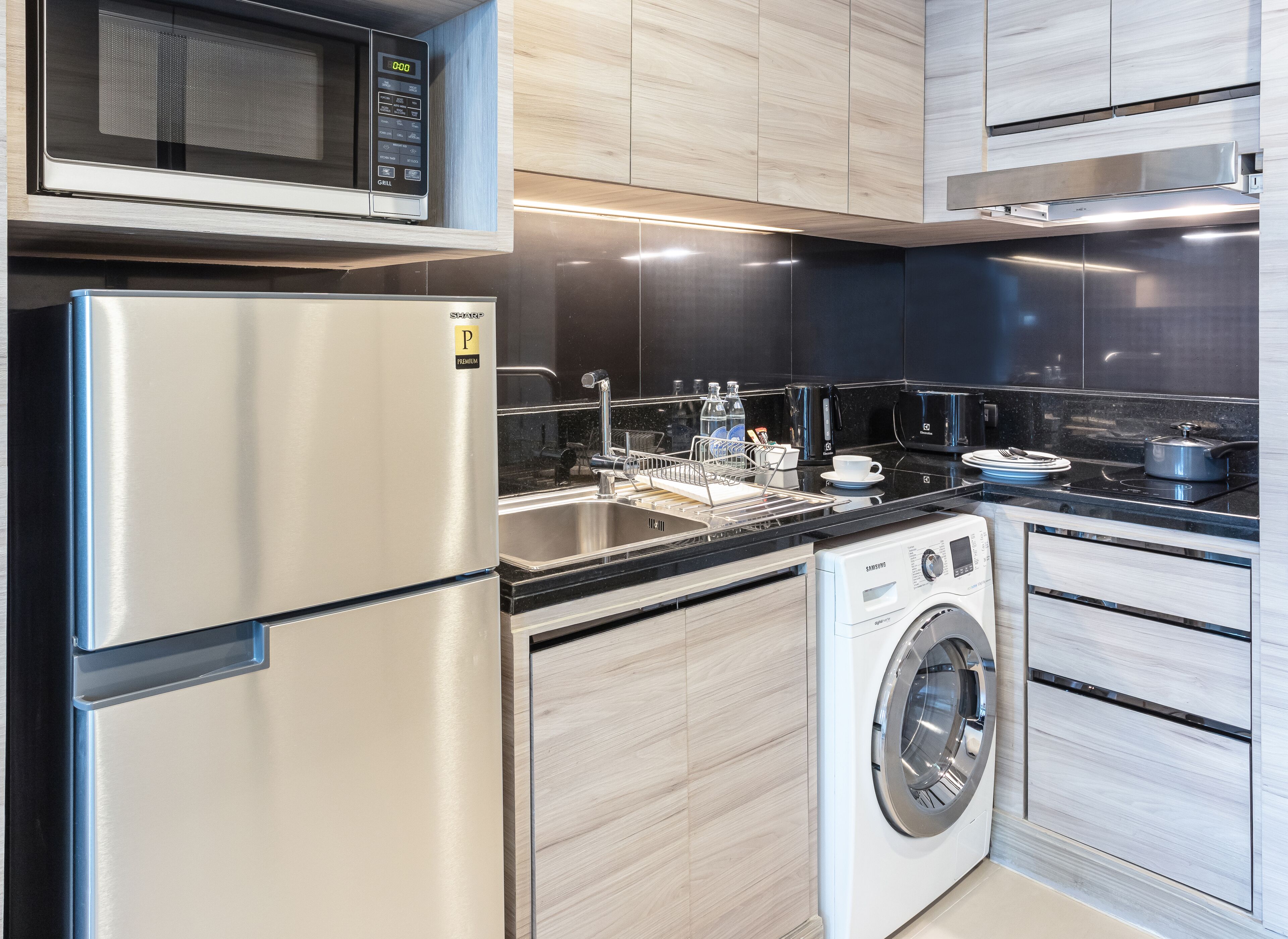 premium suite | private kitchen | full-sized fridge, microwave, stovetop, cookware/dishes/utensils