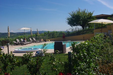 Alberca al aire libre por temporada y sombrillas en la alberca