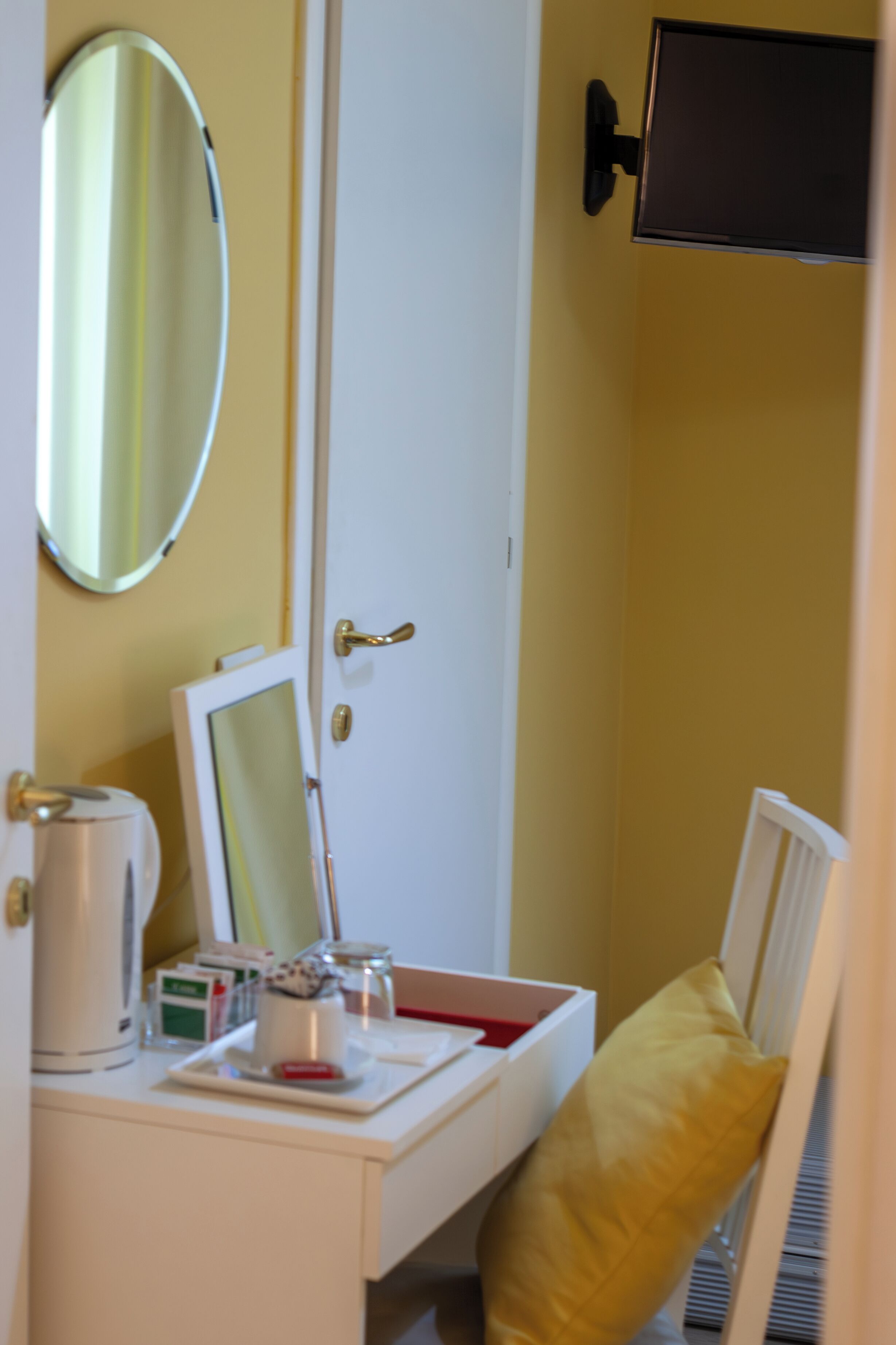 A bathroom with a white sink, a mirror, a towel rack, and a toilet.