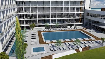 A modern hotel with multiple floors, a central swimming pool, and outdoor seating areas.