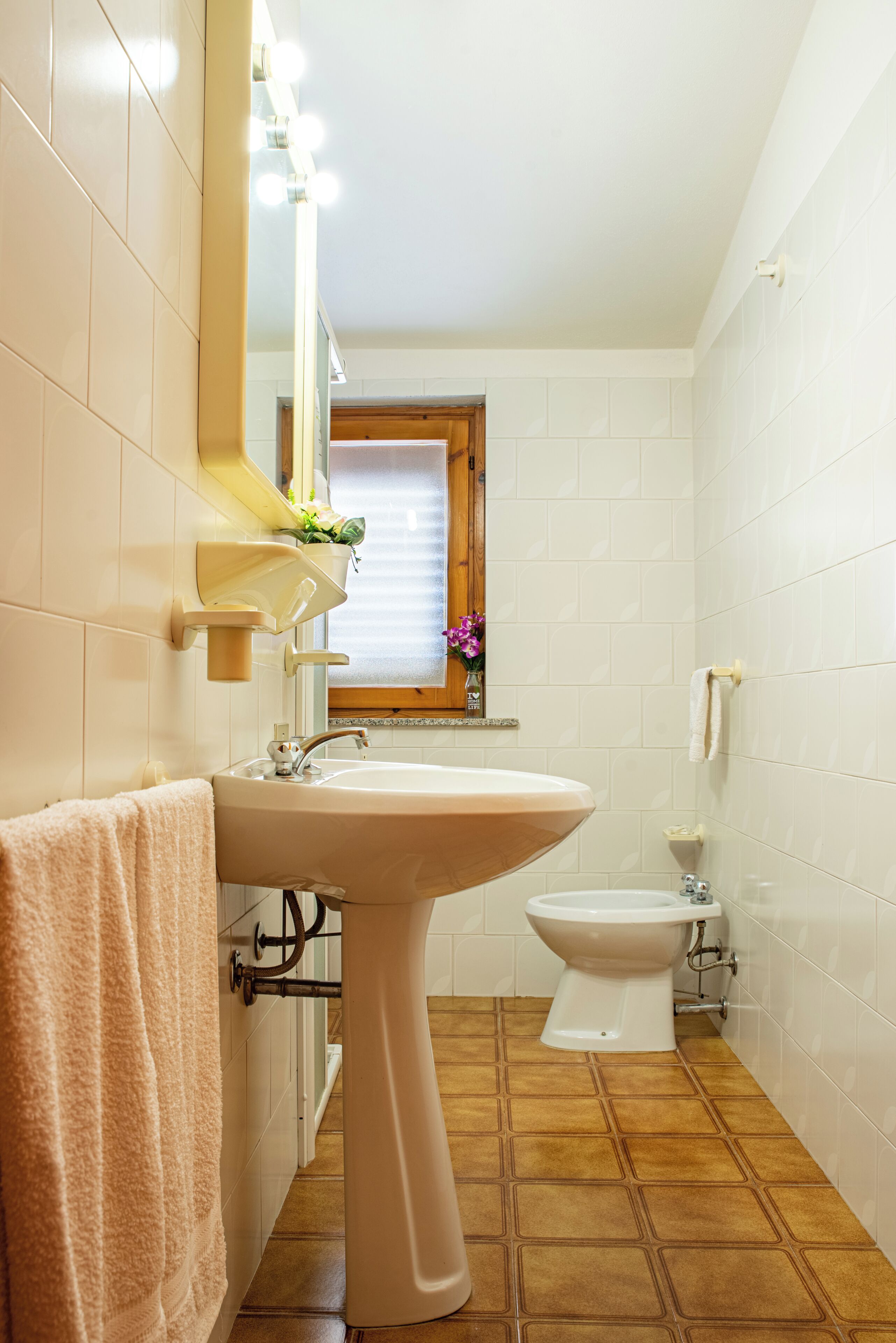 A bathroom with a sink, mirror, and toilet.