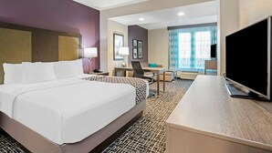 A hotel room with a large bed, a desk, a chair, and a television. - La Quinta Inn & Suites by Wyndham Corpus Christi - Portland (Portland)