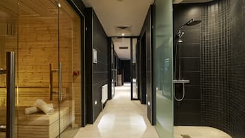 Experience the clean and contemporary design of our hotel's minimalist corridors, featuring a relaxation area and modern shower facilities.