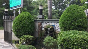 A sign for 'The Galorilla Bed and Breakfast' with a stone wall and a small waterfall feature. - The Gabriella B&B (Tagbilaran)