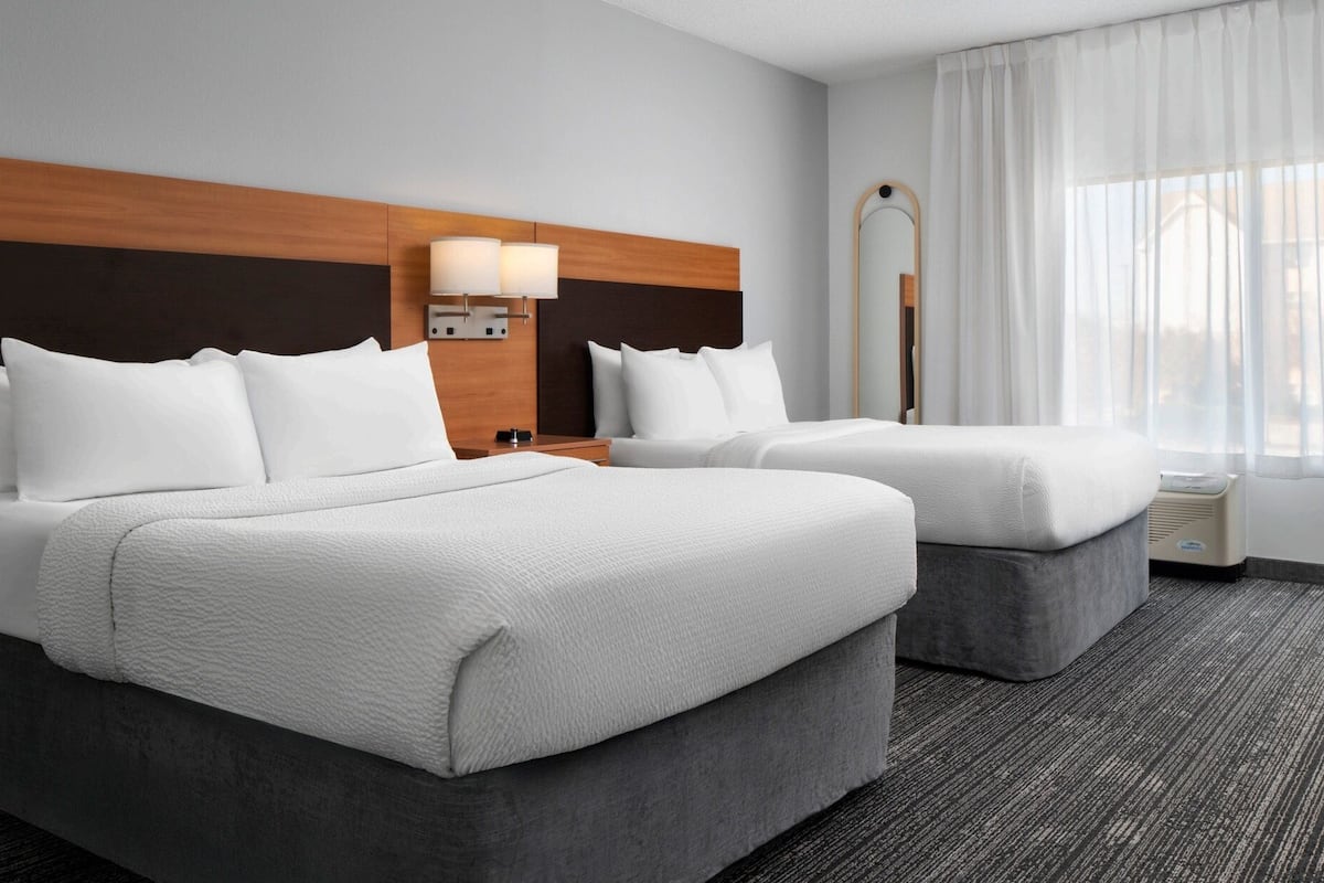 Premium bedding, pillow-top beds, desk, laptop workspace