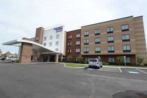 Welcome to Fairfield Inn & Suites, featuring a modern design with a covered entrance and ample parking.