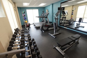 A gym with exercise equipment, a bench, and a mirror. - Fairfield Inn & Suites Bowling Green (Bowling Green)