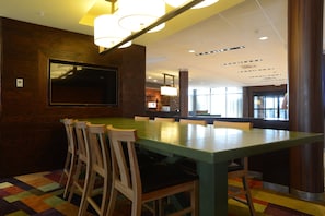 A conference room with a long table, several chairs, a flat-screen TV mounted on the wall, and a colorful carpet. - Fairfield Inn & Suites Bowling Green (Bowling Green)