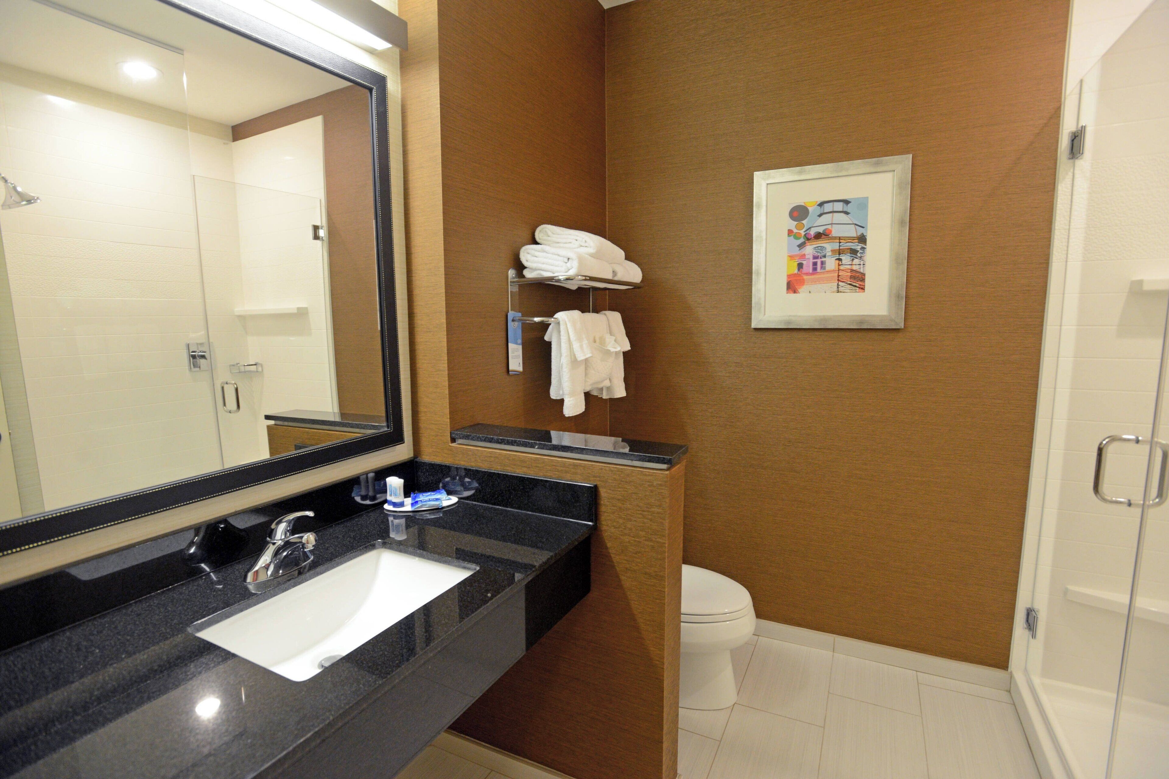 combined shower/bathtub, designer toiletries, hair dryer, towels