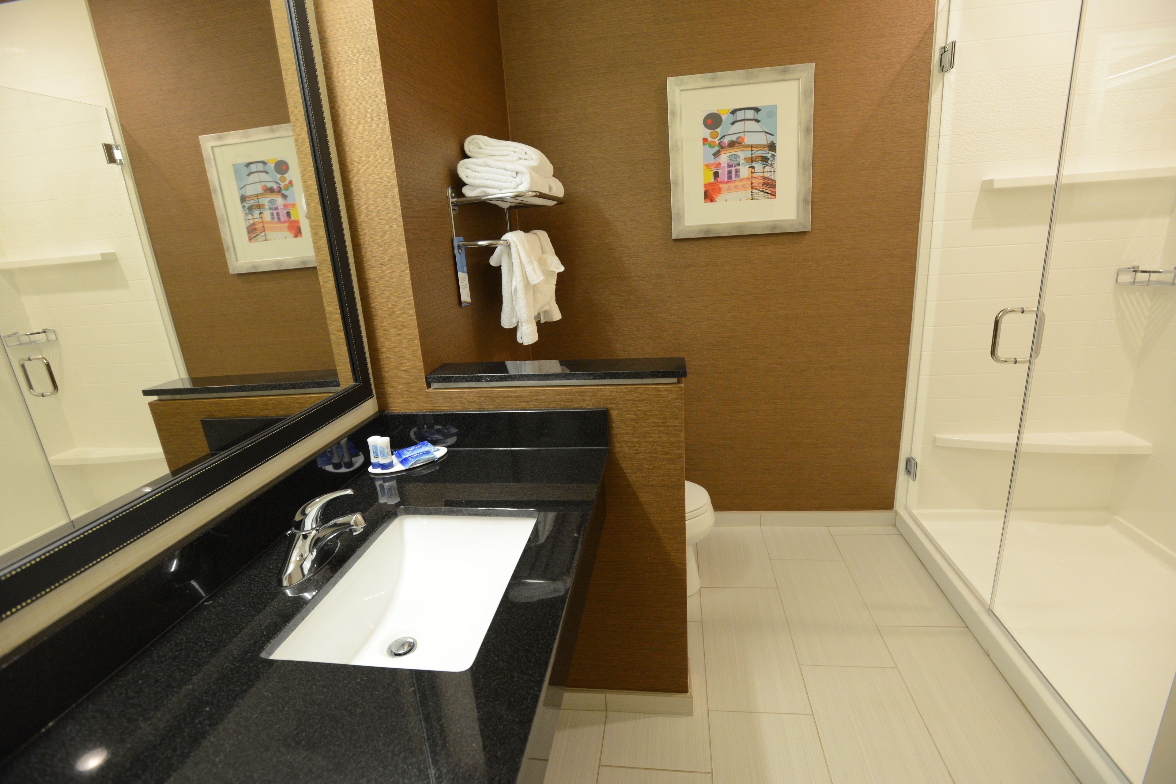 combined shower/bathtub, designer toiletries, hair dryer, towels