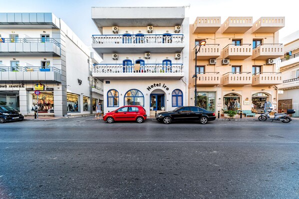 A hotel with a white facade, blue-framed windows, and balconies with railings. - Iro Hotel (Hersonissos)