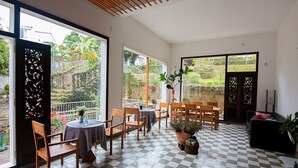 A spacious room with a checkered floor, large windows, and a balcony with a view of greenery. - Lu Tan Residence (Xuan Huong - Da Lat)