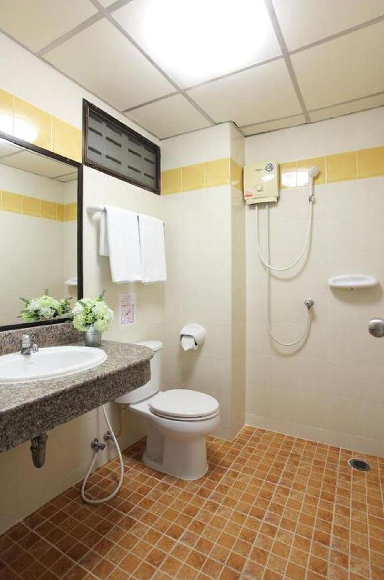 A bathroom with a sink, toilet, and shower.
