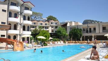 Relax by the resort's pool, surrounded by lounge chairs and umbrellas, and enjoy the water slide.