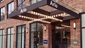 A brick building with a covered entrance labeled "Arlo." - Arlo SoHo (New York)