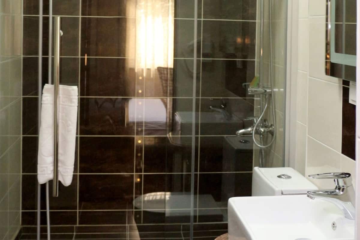 superior single room | bathroom | shower, free toiletries, hair dryer, dressing gowns