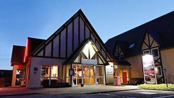 A building with a prominent triangular roof and a sign indicating it is a restaurant.
