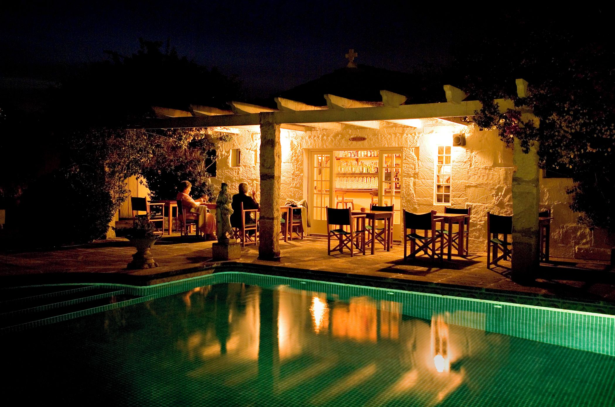A poolside area with a bar and seating.